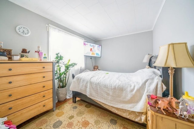 bedroom with ornamental molding