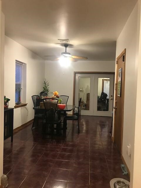 tiled dining room with ceiling fan