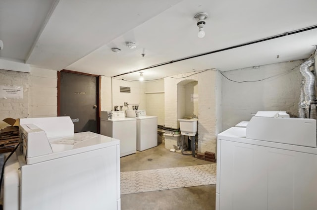 laundry room featuring washer and dryer and sink