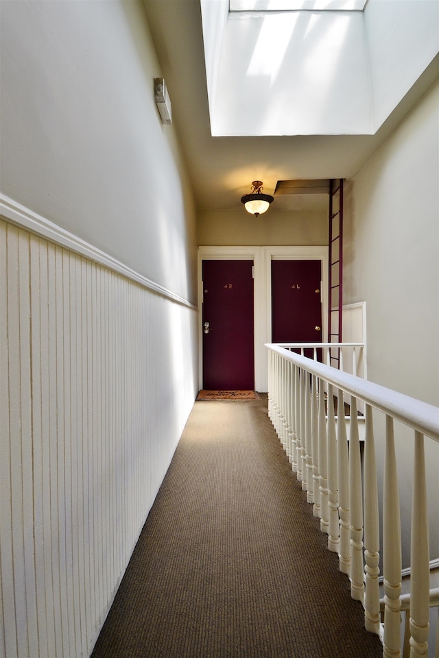 hall featuring carpet flooring