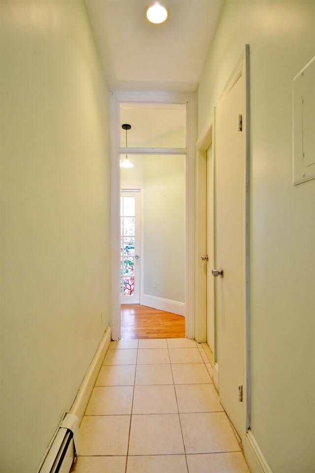 hall with light hardwood / wood-style flooring and baseboard heating