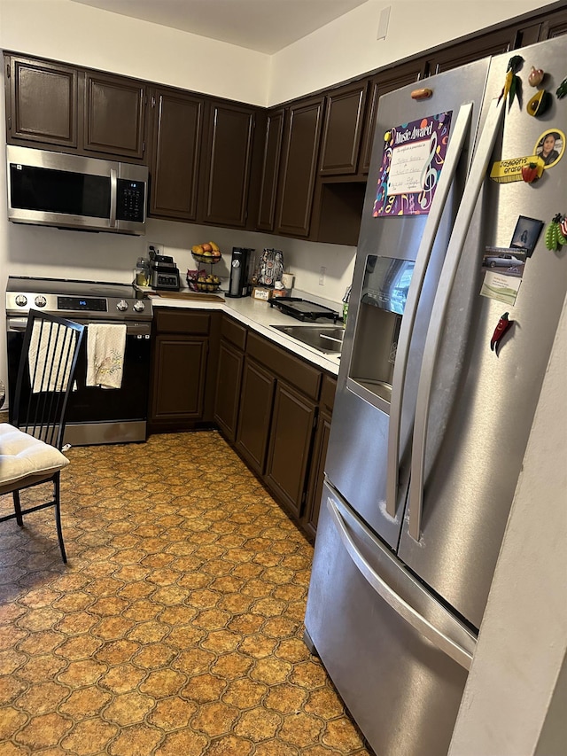 186 Highlands Ave Unit 5A, Clifton, NJ 07011 - kitchen with appliances with stainless steel finishes, a sink, light countertops, and dark brown cabinetry