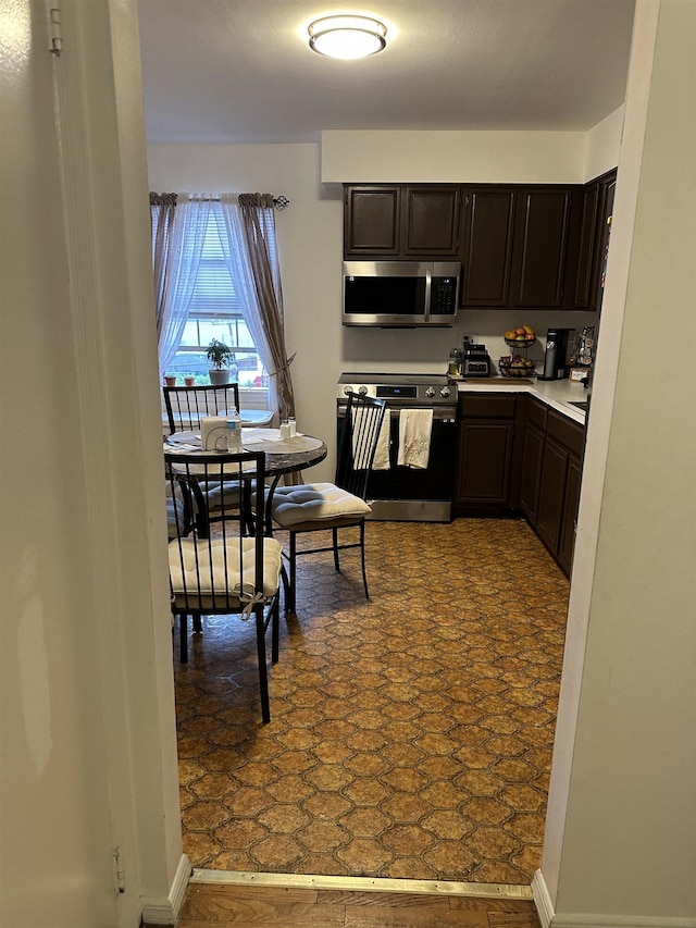 186 Highlands Ave Unit 5A, Clifton, NJ 07011 - kitchen featuring appliances with stainless steel finishes, light countertops, and dark brown cabinets