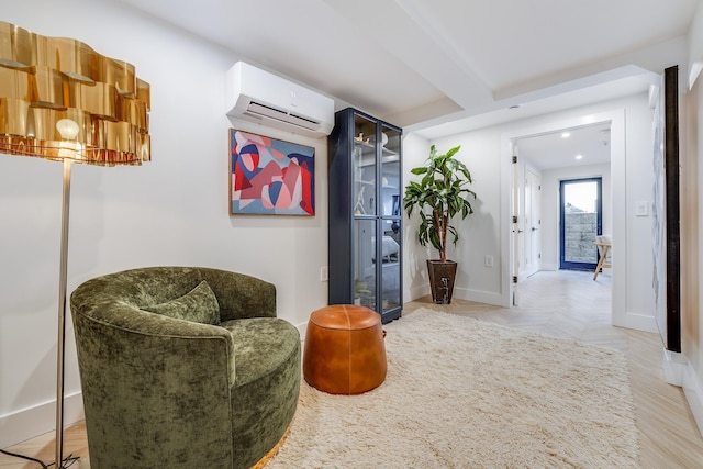 sitting room featuring a wall mounted AC, recessed lighting, beam ceiling, and baseboards