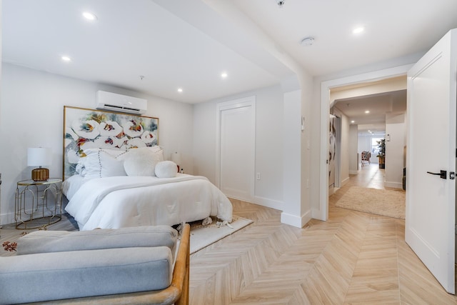 bedroom featuring baseboards, an AC wall unit, and recessed lighting