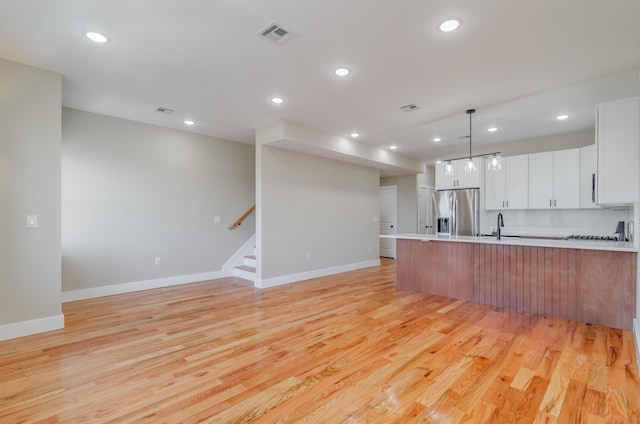 275 Pearsall Ave Unit 2, Jersey City, NJ 07305 - kitchen featuring light countertops, stainless steel refrigerator with ice dispenser, recessed lighting, and light wood-type flooring