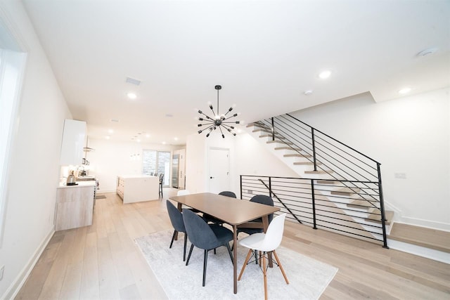 dining area featuring baseboards, visible vents, light wood-style floors, a notable chandelier, and recessed lighting