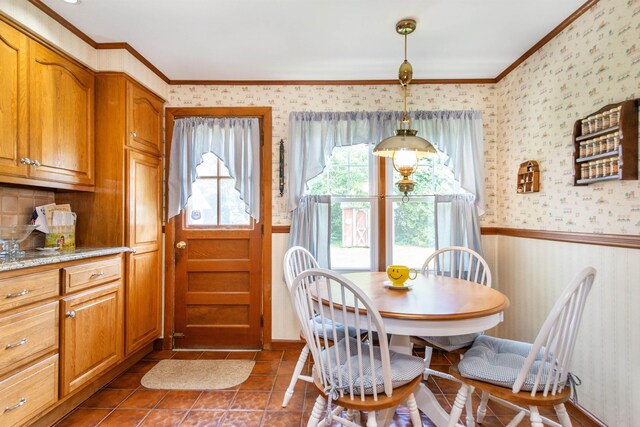 532 Passaic Ave, Nutley, NJ 07110 - dining area with wallpapered walls, ornamental molding, dark tile patterned flooring, and wainscoting