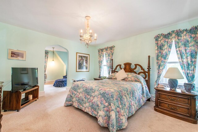 532 Passaic Ave, Nutley, NJ 07110 - bedroom featuring multiple windows, carpet, a chandelier, and arched walkways