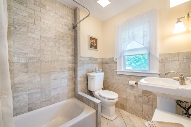 532 Passaic Ave, Nutley, NJ 07110 - bathroom with a tub, tile walls, toilet, tile patterned flooring, and wainscoting