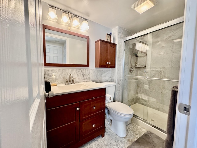 full bathroom featuring visible vents, toilet, tile walls, a shower stall, and vanity