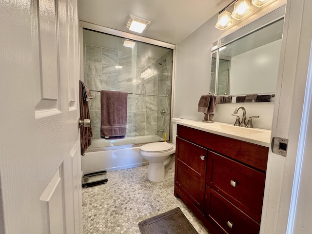 full bath with enclosed tub / shower combo, toilet, and vanity