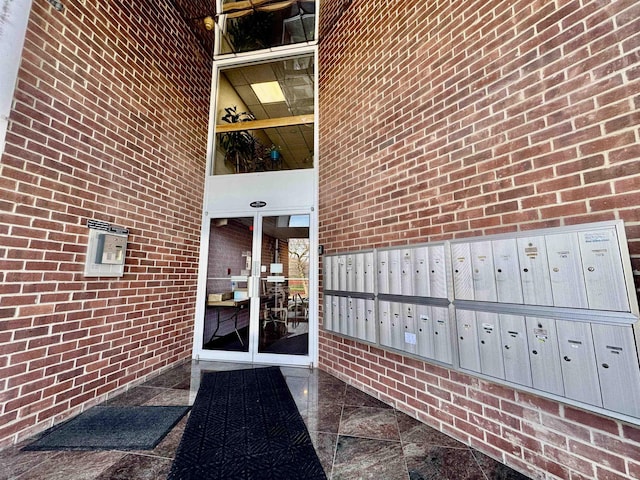 view of exterior entry with brick siding