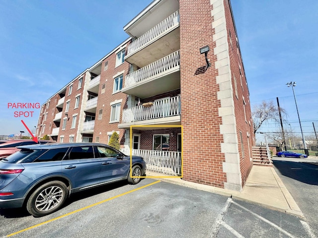 view of building exterior featuring uncovered parking