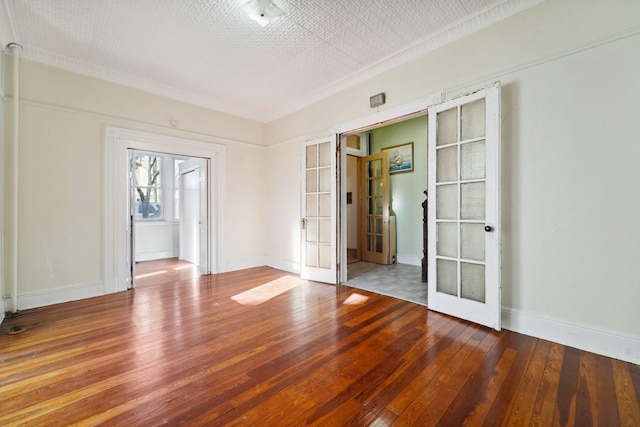 unfurnished room with wood-type flooring and french doors