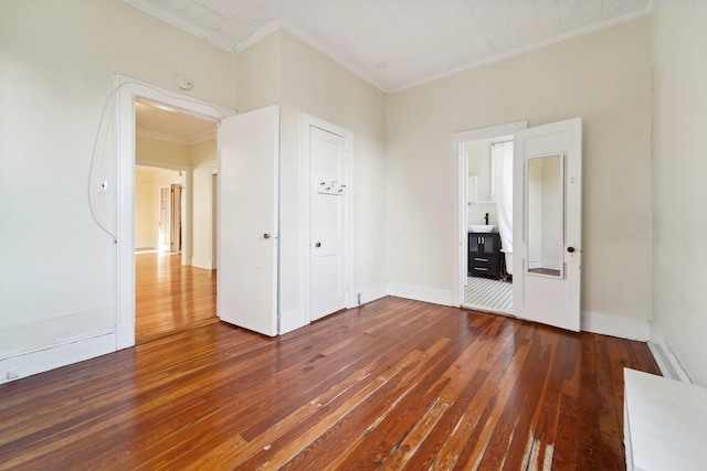 unfurnished room featuring dark wood-type flooring and ornamental molding