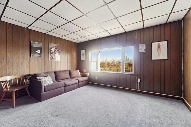 unfurnished living room with carpet floors and wood walls