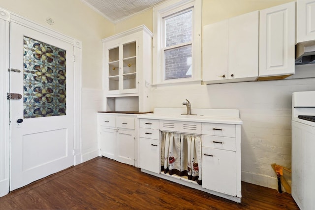 kitchen featuring dark wood-type flooring, white cabinetry, and crown molding