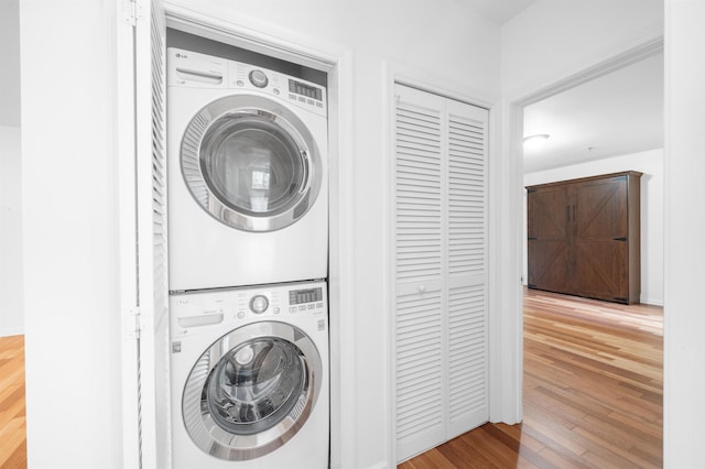 650 2nd St Unit 3C, Hoboken, NJ 07030 - laundry room featuring stacked washer / dryer and wood finished floors