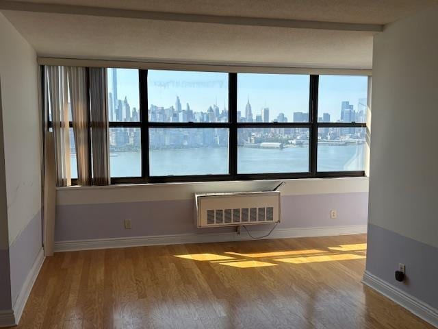 7002 Boulevard Dr Unit 30E, Guttenberg, NJ 07093 - empty room with a skyline view, wood finished floors, and healthy amount of natural light