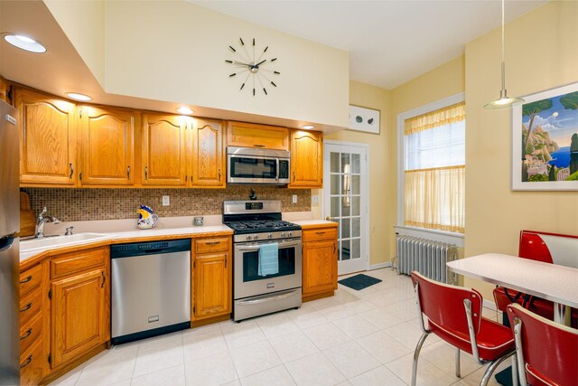 895 Summit Ave, Jersey City, NJ 07307 - kitchen featuring appliances with stainless steel finishes, radiator heating unit, a sink, and light countertops