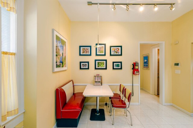 895 Summit Ave, Jersey City, NJ 07307 - dining space with rail lighting, tile patterned floors, and baseboards