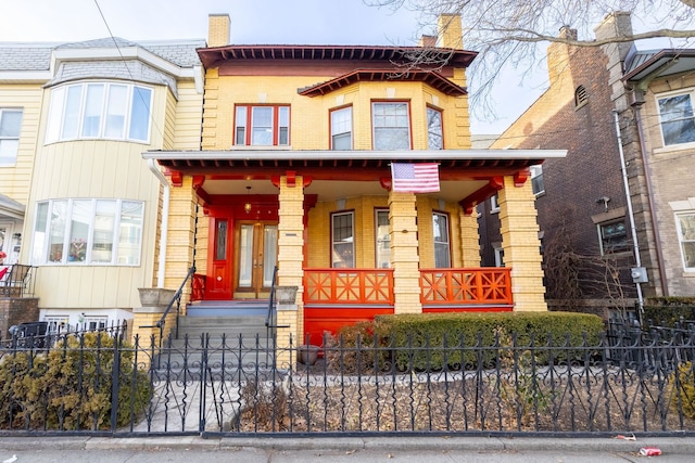 895 Summit Ave, Jersey City, NJ 07307 - view of front of house with brick siding, a porch, and a fenced front yard