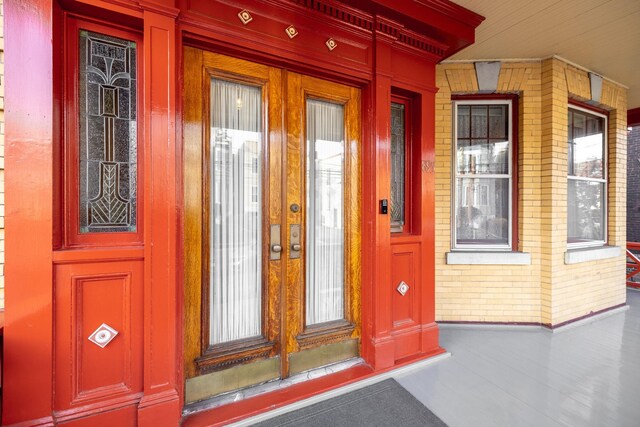 895 Summit Ave, Jersey City, NJ 07307 - doorway to property with covered porch, french doors, and brick siding