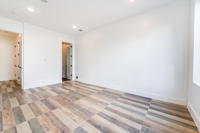 unfurnished room with hardwood / wood-style flooring