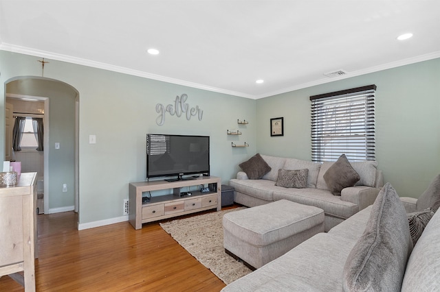 living room featuring light hardwood / wood-style flooring and crown molding