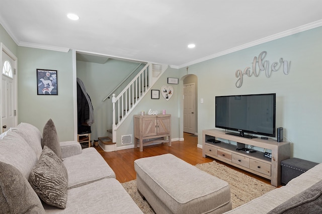 living room featuring hardwood / wood-style flooring and ornamental molding