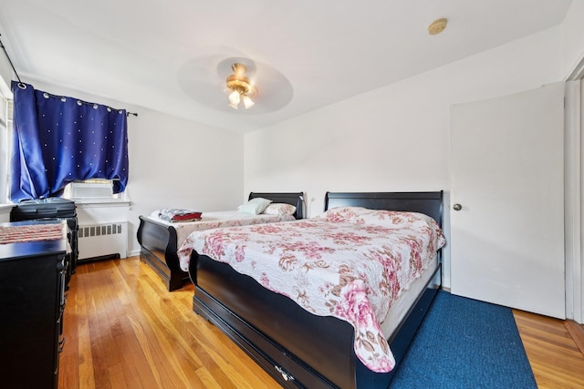 2520 Kennedy Blvd Unit 4C, Jersey City, NJ 07304 - bedroom featuring radiator heating unit, wood finished floors, and a ceiling fan
