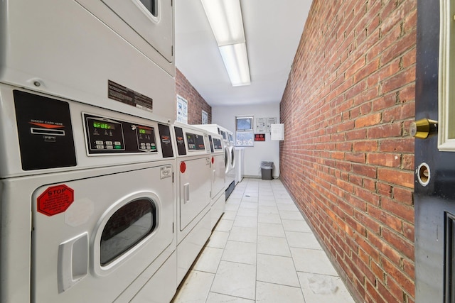 2520 Kennedy Blvd Unit 4C, Jersey City, NJ 07304 - community laundry with brick wall, stacked washing machine and dryer, light tile patterned floors, and washer and dryer