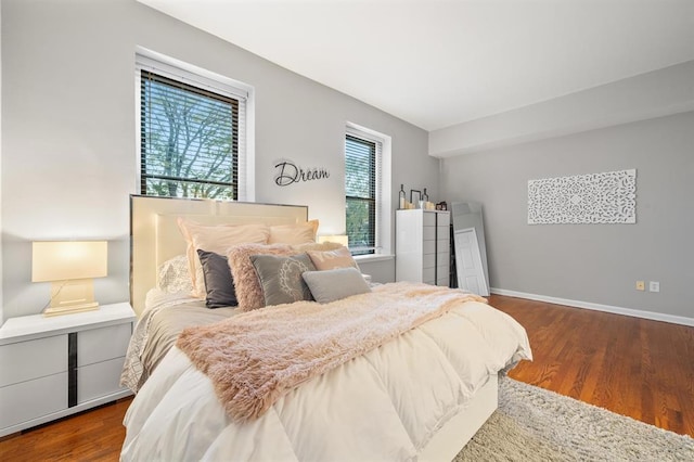 bedroom featuring dark wood-style floors and baseboards
