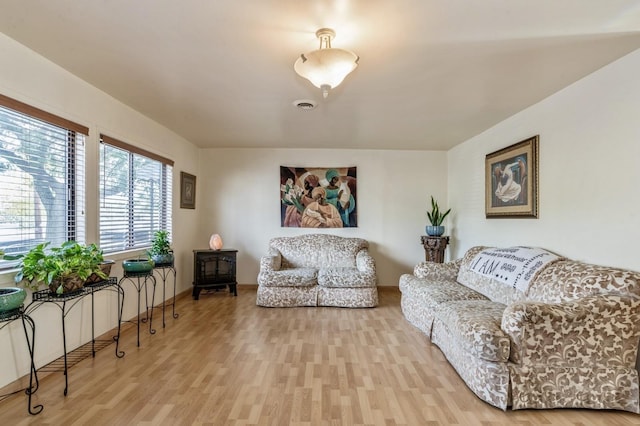 living room featuring wood finished floors and visible vents