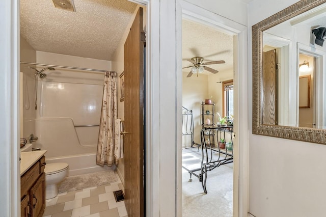 full bathroom featuring shower / tub combo with curtain, toilet, a textured ceiling, vanity, and ceiling fan