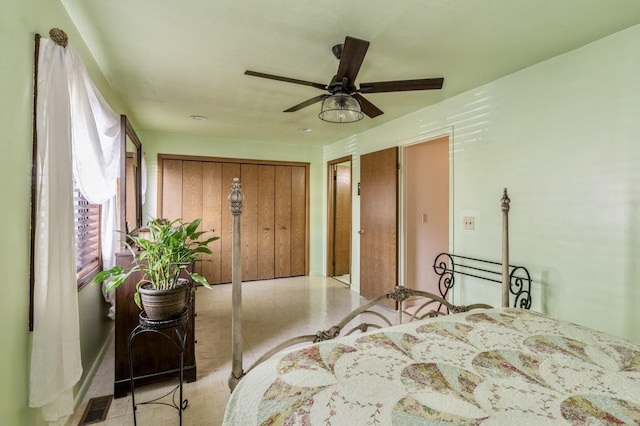 bedroom with a ceiling fan, visible vents, and a closet