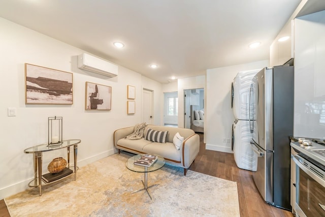 living room with light hardwood / wood-style flooring and a wall mounted air conditioner