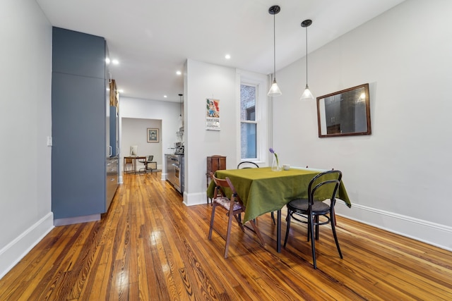 dining area featuring recessed lighting, baseboards, and hardwood / wood-style flooring