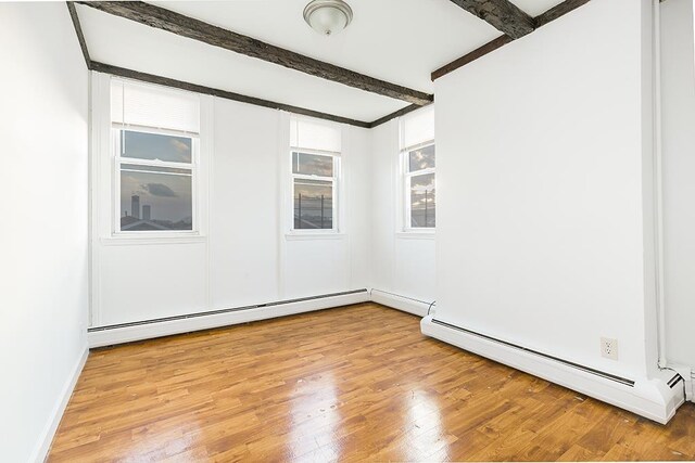 148 S St, Jersey City, NJ 07307 - unfurnished room with a baseboard heating unit, beamed ceiling, and light wood finished floors