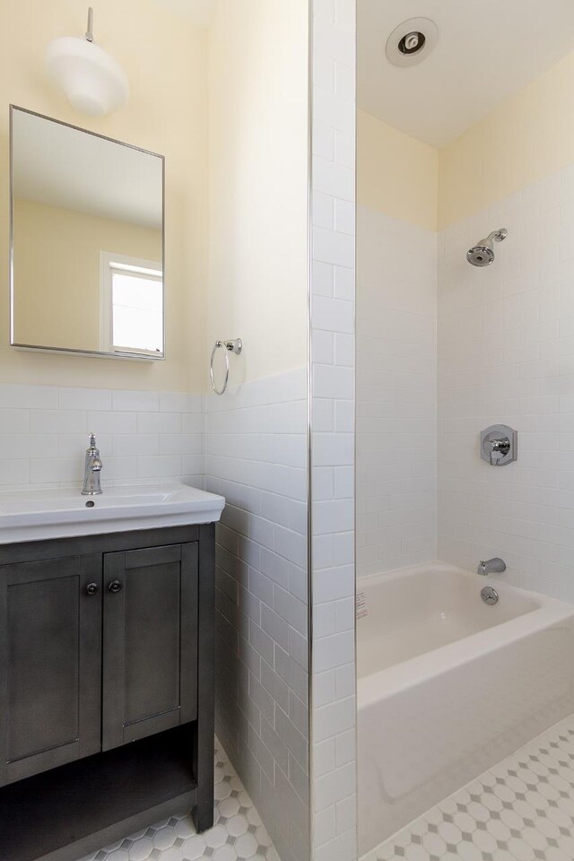 148 S St, Jersey City, NJ 07307 - full bathroom featuring tile walls, vanity, shower / bathtub combination, wainscoting, and tile patterned floors