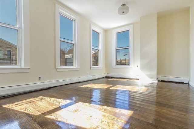 148 S St, Jersey City, NJ 07307 - unfurnished room featuring baseboard heating and wood finished floors