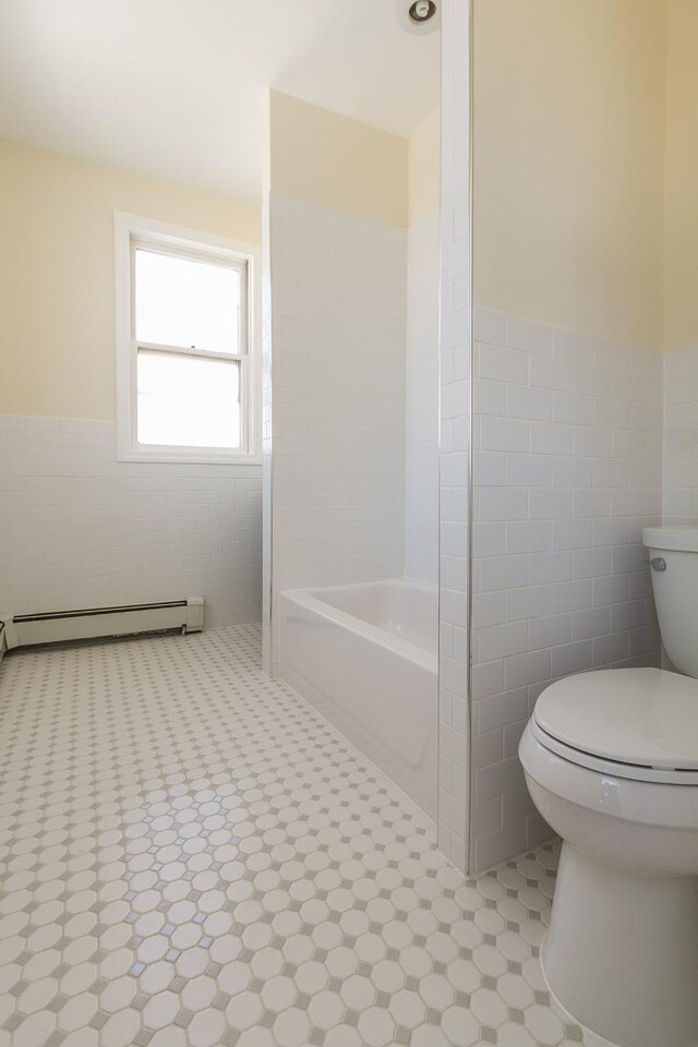 148 S St, Jersey City, NJ 07307 - full bathroom with tile walls, a baseboard radiator, a tub to relax in, and a wainscoted wall
