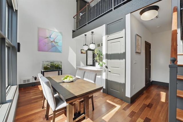 245 Ogden Ave Unit 2, Jersey City, NJ 07307 - dining room with wood finished floors, a high ceiling, and baseboards
