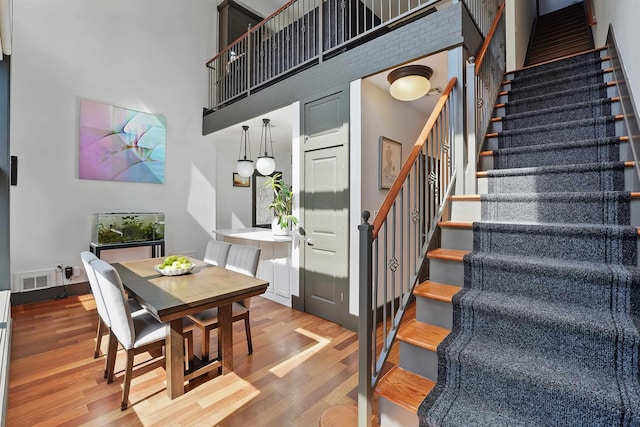 245 Ogden Ave Unit 2, Jersey City, NJ 07307 - staircase with wood finished floors and a high ceiling