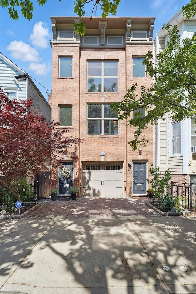 245 Ogden Ave Unit 2, Jersey City, NJ 07307 - townhome / multi-family property with decorative driveway, a garage, brick siding, and fence