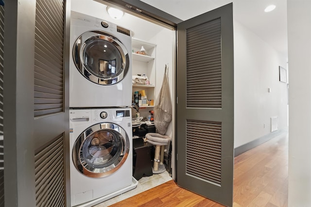245 Ogden Ave Unit 2, Jersey City, NJ 07307 - clothes washing area featuring stacked washer / dryer and wood finished floors