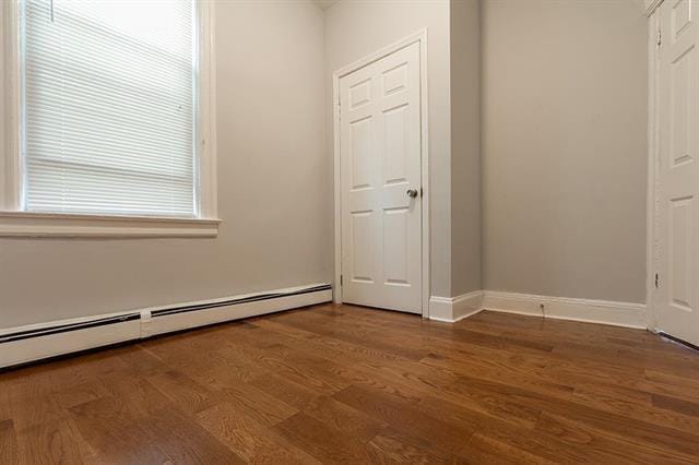 198 Myrtle Ave, Jersey City, NJ 07305 - unfurnished bedroom with a baseboard radiator and dark wood-type flooring