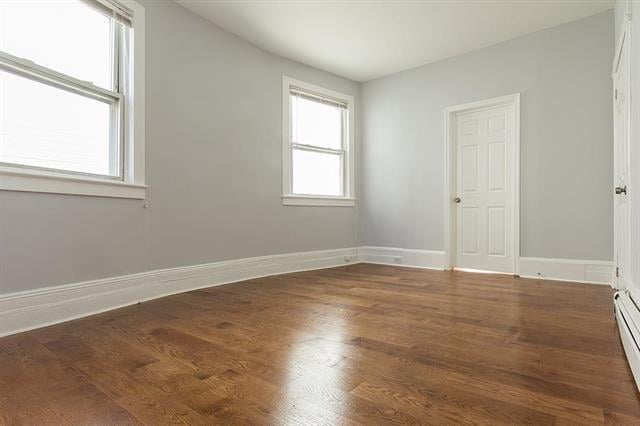 198 Myrtle Ave, Jersey City, NJ 07305 - unfurnished bedroom featuring wood finished floors and baseboard heating