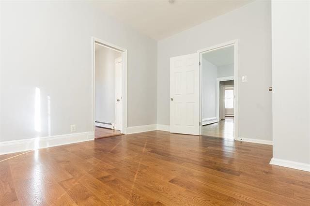 198 Myrtle Ave, Jersey City, NJ 07305 - unfurnished room featuring a baseboard radiator and wood finished floors